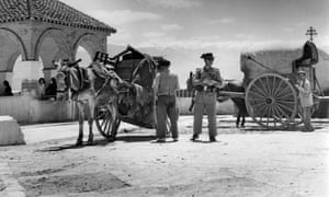 A policeman questions a peasant in Granada, Spain in 1959.