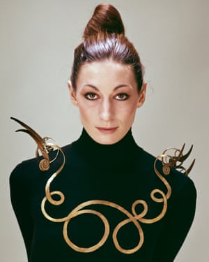 Anjelica Huston wears a black polo neck and a large gold necklace The Jealous Husband (c. 1940) by Alexander Calder, 1976, photo by Evelyn Hofer, ©2016 Calder Foundation, New York, Photo © Estate of Evelyn Hofer