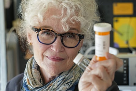 Mary Beth Orr holds medicine bottles used to give her doses of psilocybin.