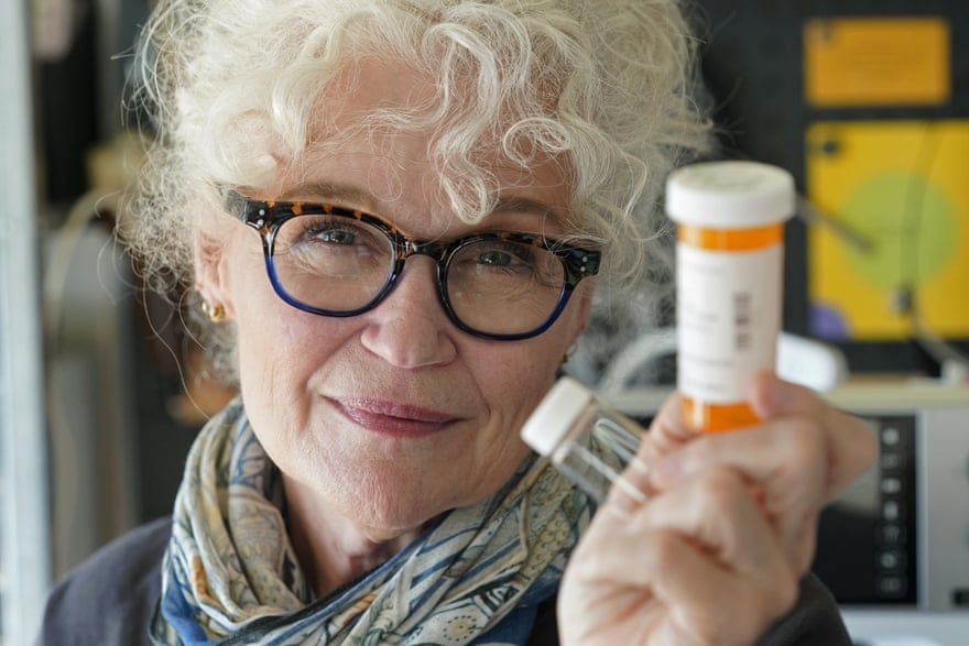 Mary Beth Orr holds medicine bottles used to give her doses of psilocybin.