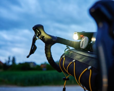 Bicycle Handlebar With Bike Light On Country Road At Dusk
