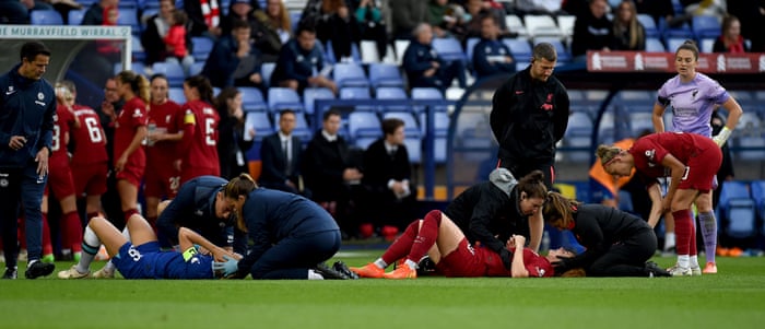Rachel Furness and Magdalena Erickson receive treatment after a head collision.
