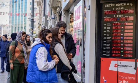 The Turkish lira is displayed alongside foreign exchange rates on 21 March in Istanbul