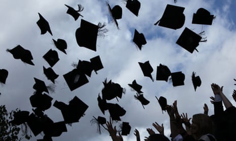 Students throw their mortarboards in the air during their graduation photograph at the University of Birmingham.