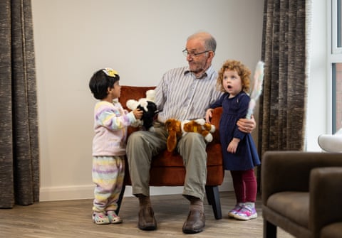 Belong resident Bill Jones with toddlers Serah Savio and Ashleigh Evans.