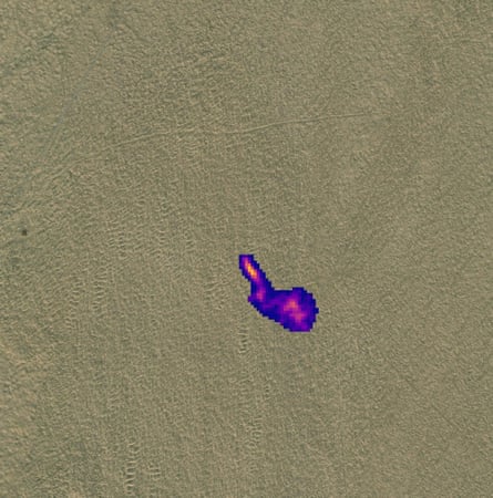 A satellite image of a sandy desert with a purple and pink pixellated area indicating methane emissions