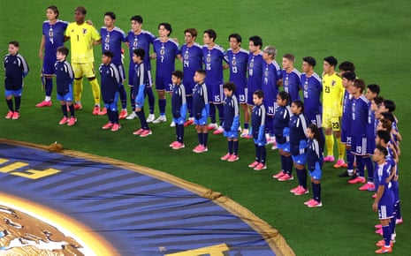 Japan players line up wearing blue