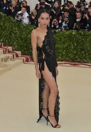 Zoe Kravitz’s black Saint Laurent dress served double time. The left side of the actor’s gown was all long-sleeved lace, yet the right side was held together with just two strategically placed ribbons.