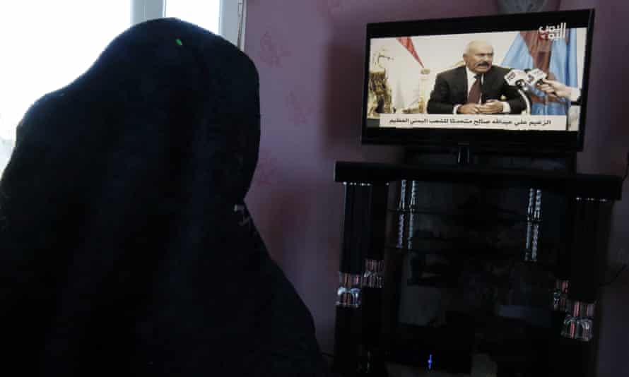 A Yemeni woman watches the former president Ali Abdullah Saleh’s television interview.