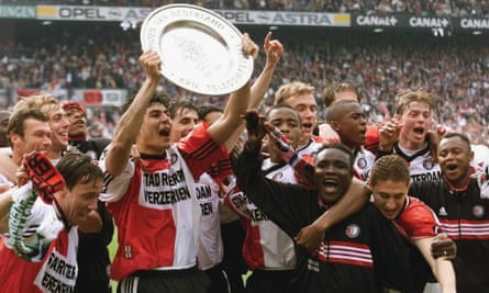 Julio Cruz holds the trophy as the Feyenoord players celebrate winning their 14th title in 1999.