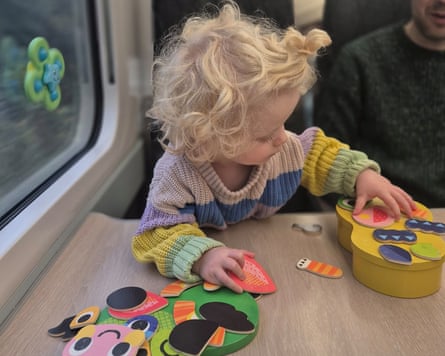 A child playing with toys on a train