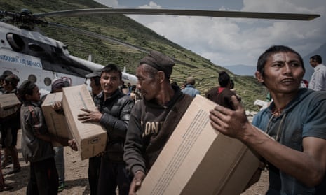 Volunteers unload relief supplies in a remote area after the 2015 earthquake. 