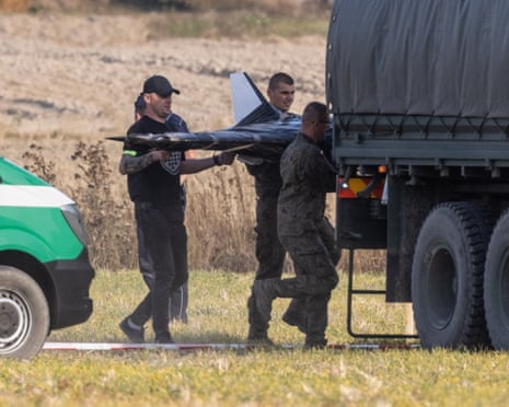 Polish Territorial Defense Forces at the crash site of a Russian drone in the village of Wohyn, eastern Poland.
