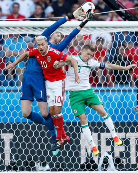 Wales’ Wayne Hennessey climbs above Aaron Ramsey and Northern Ireland’s Steven Davis to claim the ball.