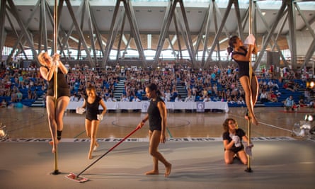 Pole cleaners work hard between each competitors performance.