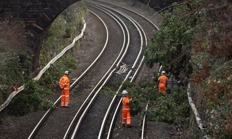 Workers clear a fallen tree from rail lines near Aigburth station in Liverpool after a storm in January