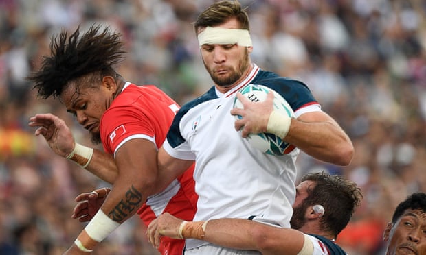 US No8 Cam Dolan catches the ball next to Tonga lock Leva Fifita during a World Cup game in Japan in 2019.