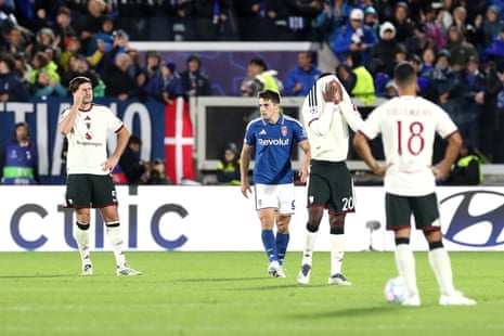Manchester United players react dejectedly after Como score during a Champions League match