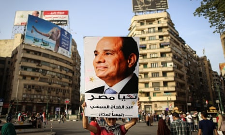 A man holds up a portrait of the Egyptian president, Abdel Fatah al-Sisi, in Cairo’s Tahrir Square
