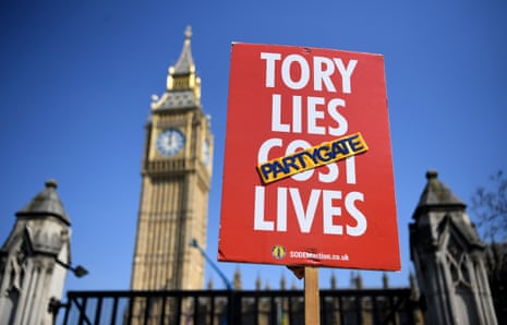 An anti-Tory banner being held up outside parliament today.
