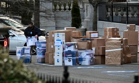 A worker moves a box out of the Eisenhower Executive Office Building on the White House grounds in Washington before the departure of former US President Donald Trump on January 14, 2021.