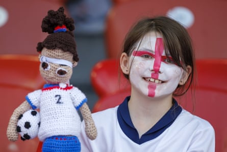 An England fan holds a Lucy Bronze doll prior to the Euro 2025 group game against France.