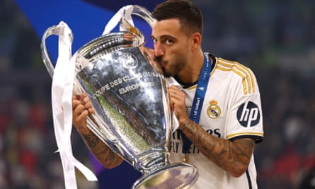 Joselu kisses the Champions League trophy