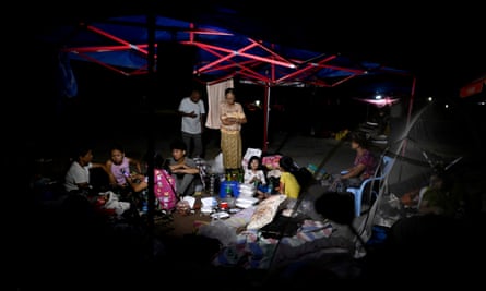 People taking shelter in tents set up outdoors in Mandalay.