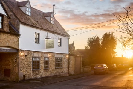 Sunset in background, pub called the Bat and Ball in Oxfordshire in foreground