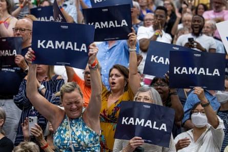 people with signs saying kamala