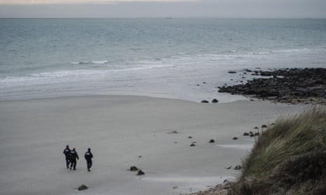 French police officers patrol on a beach in Wimereux, northern France