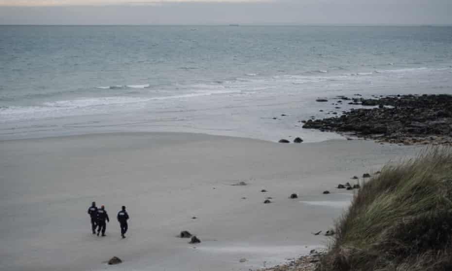French police officers patrol on a beach in Wimereux, northern France