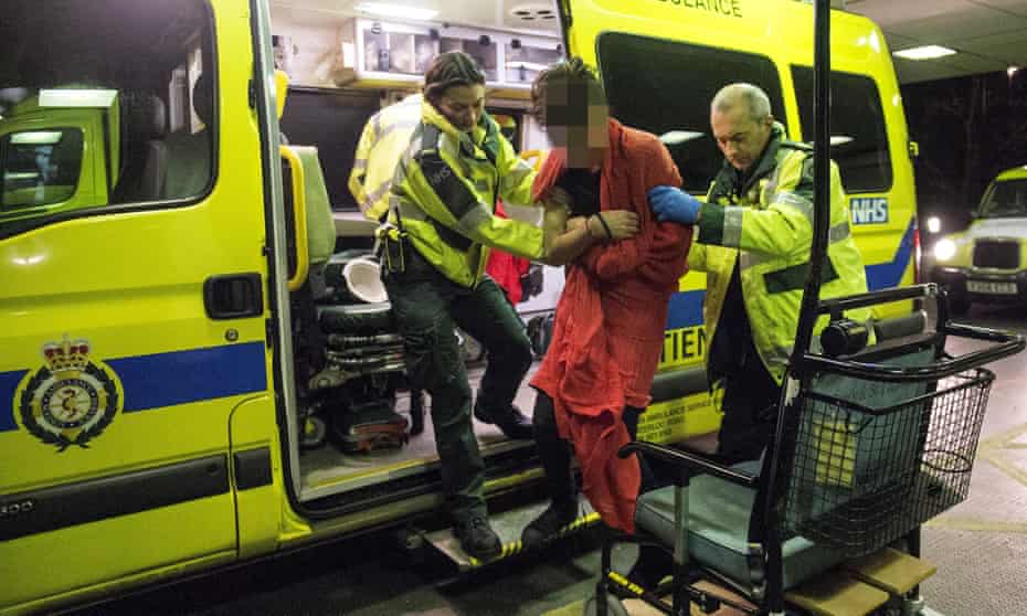 Paramedics help a drunken man in to A&amp;E in central London 