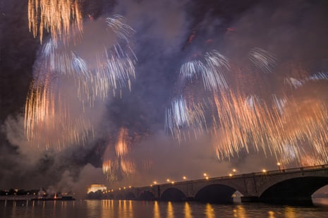 Fireworks burst over the Potomac with the Arlington Memorial Bridge and Lincoln Memorial at night
