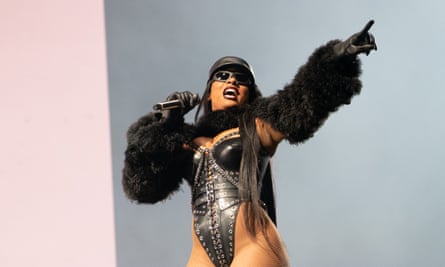 Megan Thee Stallion wearing a leather corset and fur bolero on stage at Glastonbury