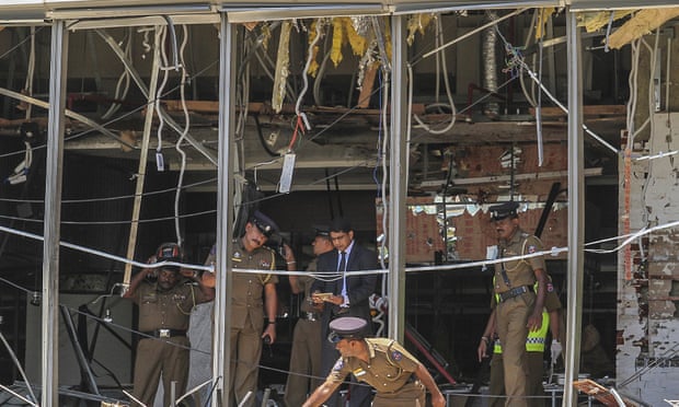 Officials inspect the site of a bombing at the Shangri-La hotel in Colombo