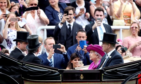 The cameras snap as the Queen and the Duke of York arrive after the royal procession on the final day of Royal Ascot.