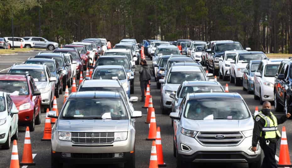Hundreds of cars line up as people wait to receive a dose of the Pfizer vaccine at a drive-thru vaccination event in Clermont, Florida.