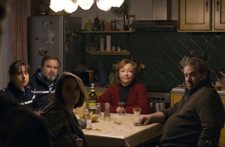 Three people and two police officers sitting round a table.