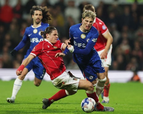 Wrexham's George Dobson fouls Chelsea's Alejandro Garnacho and is later sent off.