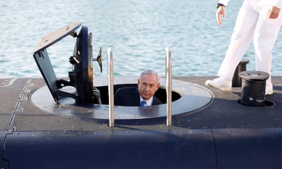 Benjamin Netanyahu climbs out after a visit inside the Rahav, the fifth submarine in the fleet, after it arrived in the port of Haifa