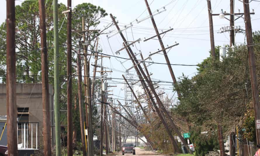 Utility poles lean over a street in Houma, Louisiana, after Hurricane Ida.
