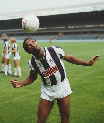 Cyrille Regis heading a football on a pitch