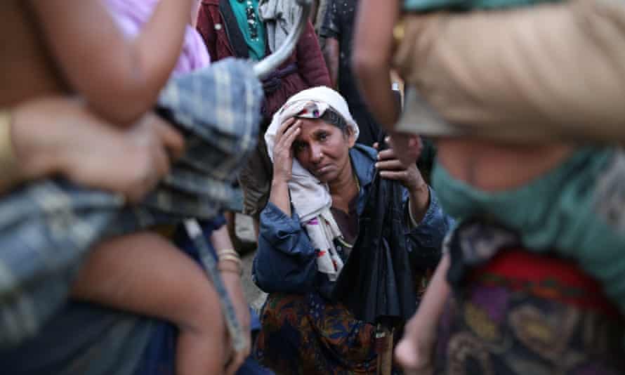 A Rohingya woman rests after fleeing Myanmar for Bangladesh