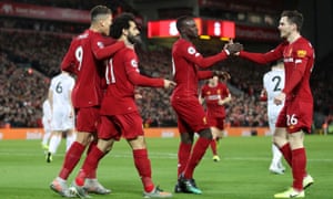 Liverpool’s Mohamed Salah celebrates scoring the opening goal with provider Andy Robertson.