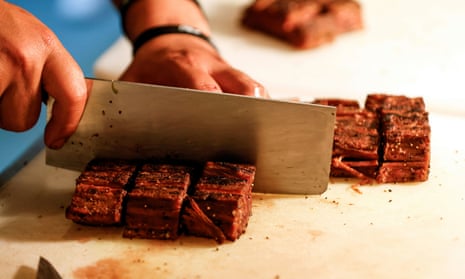 A chef cuts a 3D-printed plant-based steak produced by Redefine Meat
