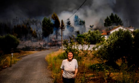 A villager shouts for help as a wildfire approaches a house at Casas da Ribeira village in Mação, central Portugal on July 2019.
