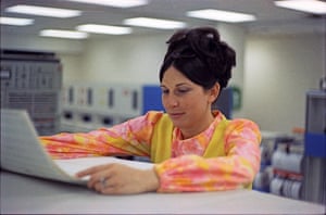 Computer operations supervisor Yvonne reads a computer printout