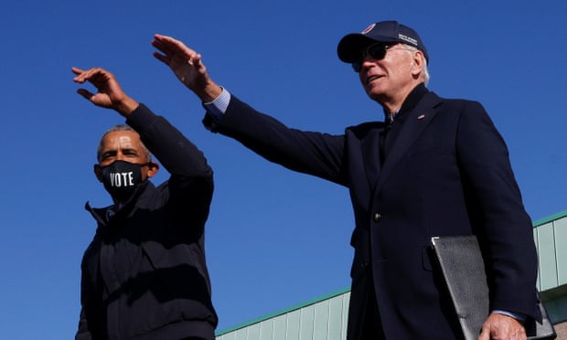 Joe Biden and former president Barack Obama at a campaign drive-in, mobilisation event in Flint, Michigan on Saturday.