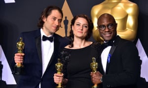 Jeremy Kleiner, Adele Romanski and Barry Jenkins pose in the press room with the Oscar for best picture.